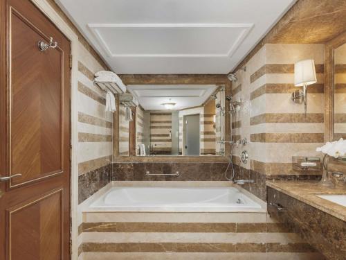 a bathroom with a tub and a sink at Swissotel Al Maqam Makkah in Makkah