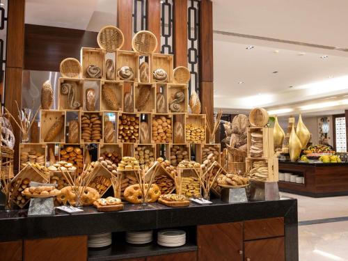 a bakery with a display of bread and pastries at Swissotel Al Maqam Makkah in Makkah