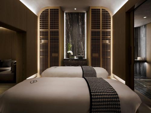 two beds sitting in a room with windows at Fairmont Century Plaza Los Angeles at Beverly Hills in Los Angeles