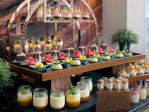 a display of desserts and drinks on a table at Swissôtel Al Murooj Dubai in Dubai