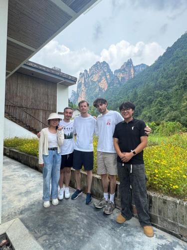 a group of people standing in front of a mountain at Avatar Peaks Resort in Zhangjiajie