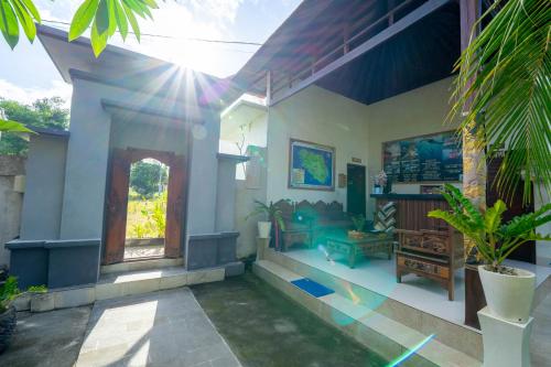 a living room of a house with the sun shining at Innora Jungle Resort And Spa in Nusa Penida