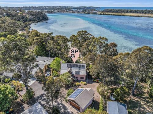 an aerial view of a house next to the water at Cornwall Cottage in Merimbula