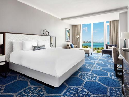 a hotel room with a large bed and a large window at Fairmont El San Juan Hotel in San Juan