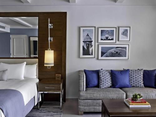 a hotel room with a bed and a couch at Fairmont El San Juan Hotel in San Juan