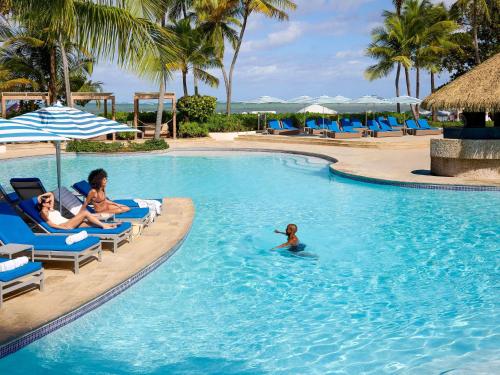 a group of people in a swimming pool at a resort at Fairmont El San Juan Hotel in San Juan