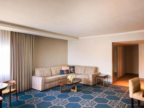 a living room with a couch and a table at Fairmont El San Juan Hotel in San Juan