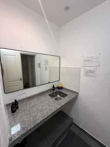 a bathroom with a sink and a mirror at Dpto CORRIENTES, Planta BAJA in Corrientes
