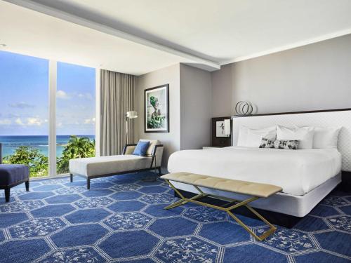 a bedroom with a large bed and a large window at Fairmont El San Juan Hotel in San Juan