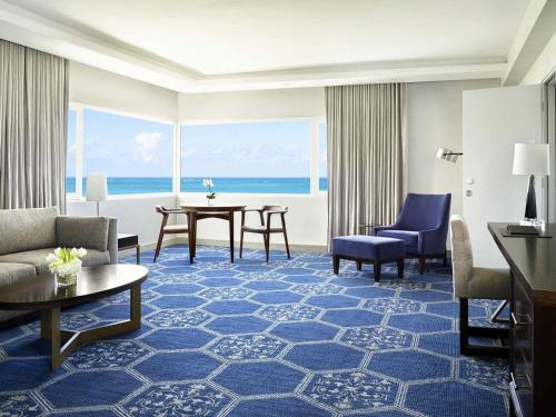 a living room with a view of the ocean at Fairmont El San Juan Hotel in San Juan