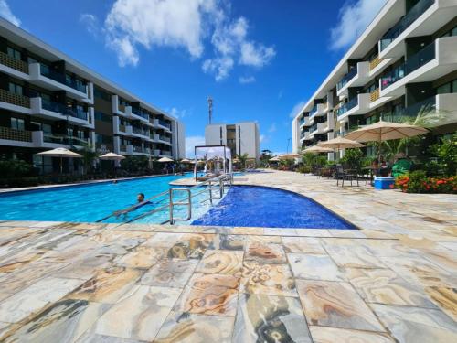 Bazén v ubytování Mana Beach Muro Alto - 2 quartos e Varanda frente piscina nebo v jeho okolí