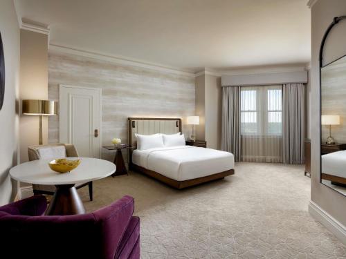 a hotel room with a bed and a table at Fairmont Hotel Macdonald in Edmonton