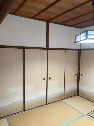 a large room with four closets in it at お宿とごはん百々 in Tanabe