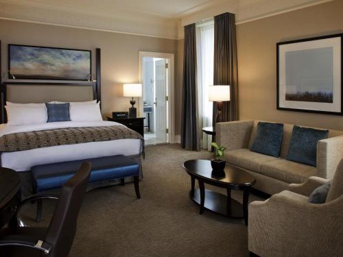 a hotel room with a bed and a couch at Fairmont Palliser in Calgary