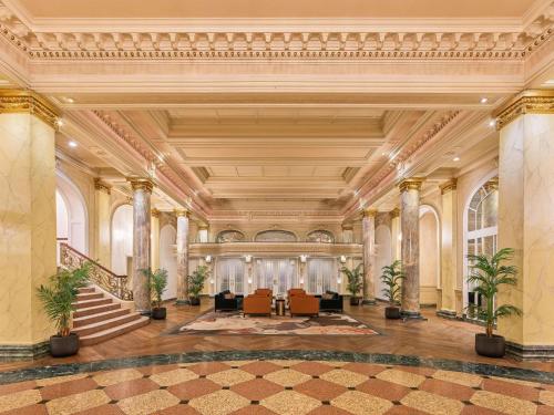 an ornate lobby with a staircase in a building at Fairmont Palliser in Calgary