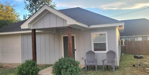 two chairs in front of a small house at Simon's casitas! in McGregor