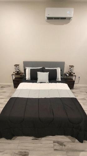 a large black and white bed in a room at Simon's casitas! in McGregor