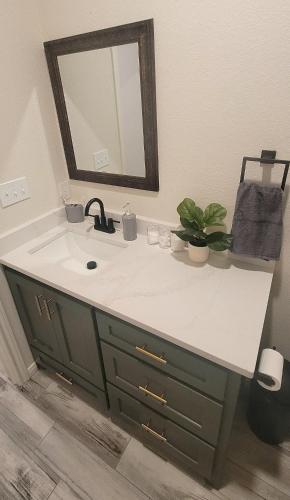 a bathroom with a sink and a mirror at Simon's casitas! in McGregor