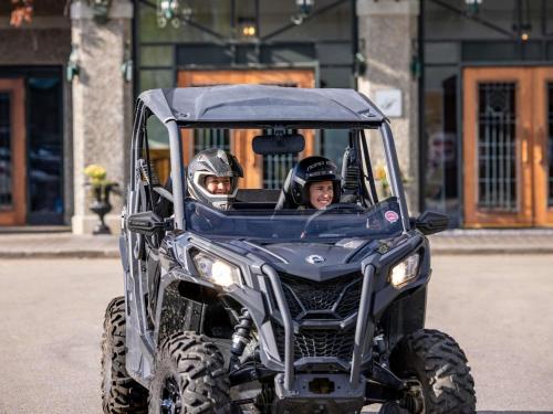 two people sitting in a atv at Fairmont Le Manoir Richelieu in La Malbaie