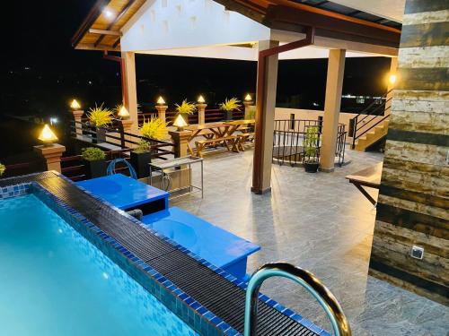 a swimming pool on a patio at night at Hotel Magdalina Lagoon in Negombo