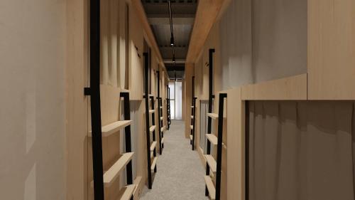 a hallway with wooden walls and shelves in a building at UNPLAN Kagurazaka in Tokyo