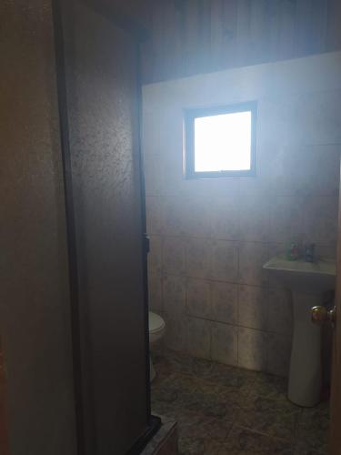 a bathroom with a window and a toilet and a sink at Casa para empresas 4 Habitaciones 2 baños in Retiro