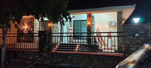 a house with a balcony at night with lights at Girivan in Alwar