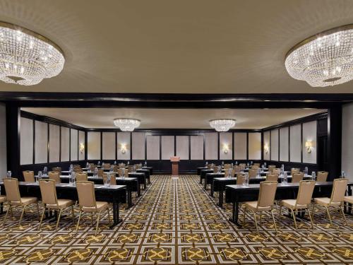 a conference room with tables and chairs and chandeliers at Fairmont Copley Plaza in Boston