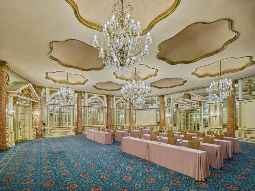 a banquet hall with chandeliers and tables in a room at Fairmont Copley Plaza in Boston