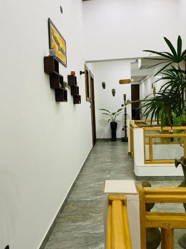 a room with tables and chairs and a white wall at Hotel Magdalina Lagoon in Negombo