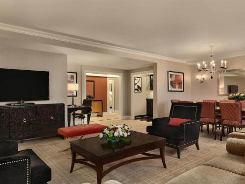 a living room filled with furniture and a flat screen tv at Fairmont Royal York Hotel in Toronto