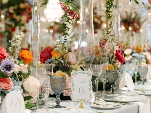 a table with glasses and flowers on it at Fairmont Royal York Hotel in Toronto