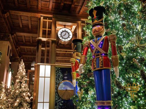 a christmas tree with a nutcracker in front of a clock at Fairmont Royal York Hotel in Toronto