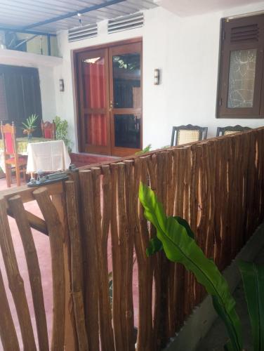 a wooden fence in front of a house at Dishari Tangalle in Tangalle