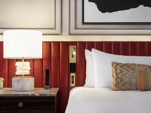 a hotel room with a bed and a table with a lamp at Fairmont Banff Springs in Banff