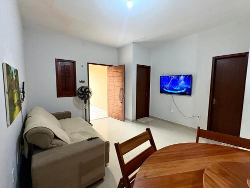 a living room with a couch and a table at Temporada AK Freitas in Parnaíba