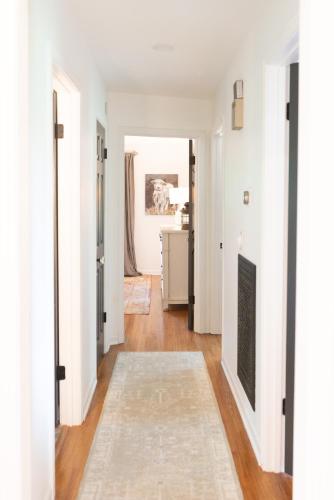 a hallway with white walls and a fireplace at Stylish Private Home 1 mile from Downtown Franklin in Franklin