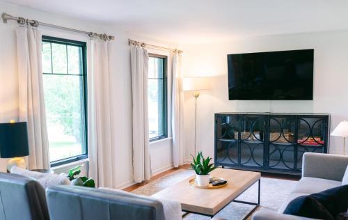 a living room with a couch and a tv at Stylish Private Home 1 mile from Downtown Franklin in Franklin