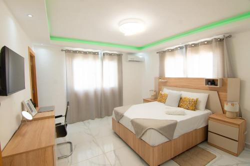 a bedroom with a large bed and a television at Hogar sweet home in Punta Cana