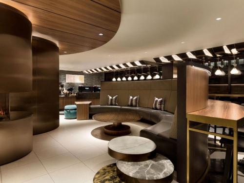 a restaurant with a couch and a table at Fairmont The Queen Elizabeth in Montréal