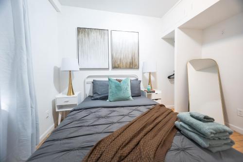 a bedroom with a large bed with blue pillows at Modern Apartment By Central Park - 3 BR in New York