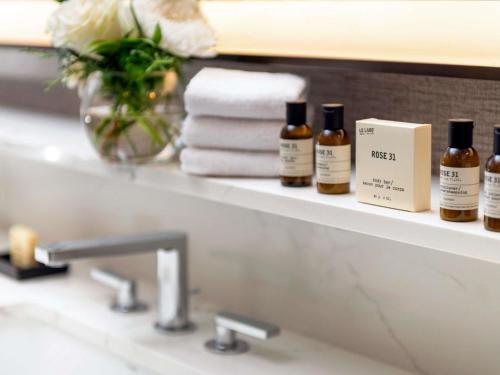 a bathroom sink with bottles of essential oils on a shelf at Fairmont Jasper Park Lodge in Jasper