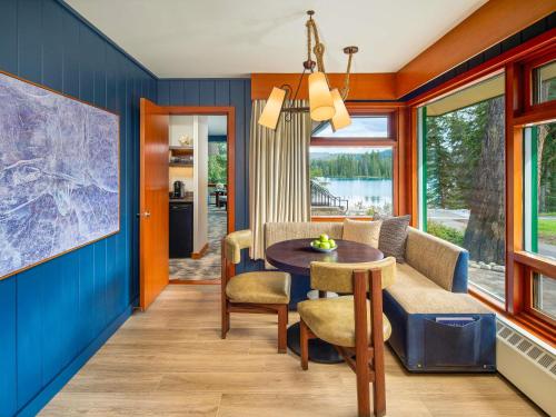 a dining room with blue walls and a table and chairs at Fairmont Jasper Park Lodge in Jasper