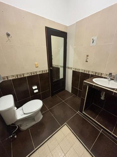 a bathroom with a toilet and a sink at AlcBalam Room in Bacalar