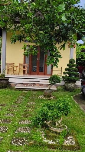 a house with a tree in front of it at Ondokhouse Taro in Gianyar