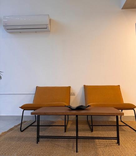 two chairs and a table in a room at Central apartment in Asunción in Asuncion