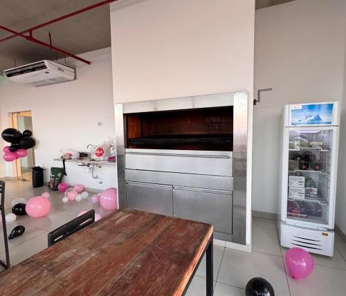 a kitchen with a wooden table and a refrigerator at Central apartment in Asunción in Asuncion