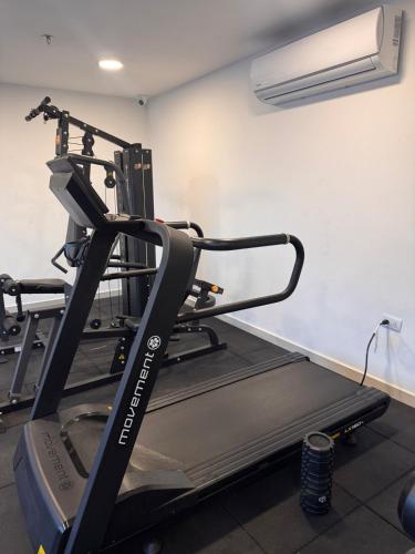 a gym with a treadmill in a room at Central apartment in Asunción in Asuncion