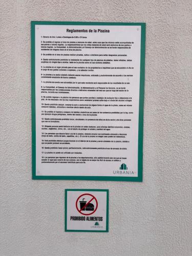 a sign is hanging on a wall with a picture of aokin at Central apartment in Asunción in Asuncion