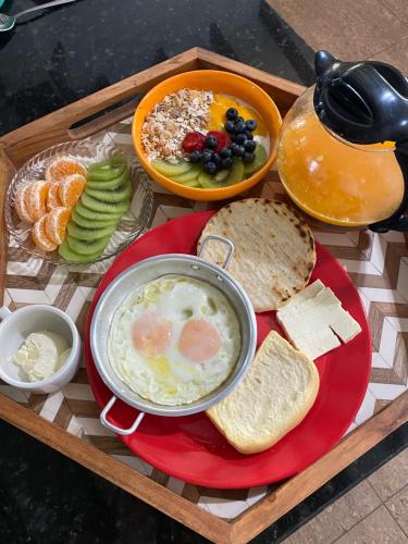 a tray of breakfast food with a bowl of eggs and bread at Cabaña Lembos Jacuzzi con vista al cielo in Pereira